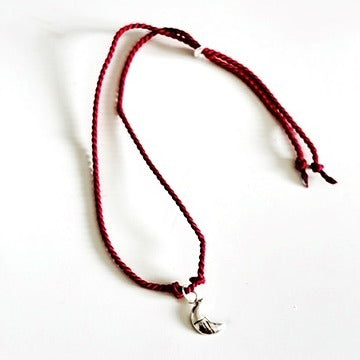 Handmade red silk string bracelet with silver leaf charm, crafted in Ireland, symbol of luck and love
Handmade red silk bracelet with silver bird charm, artisanal Irish jewellery