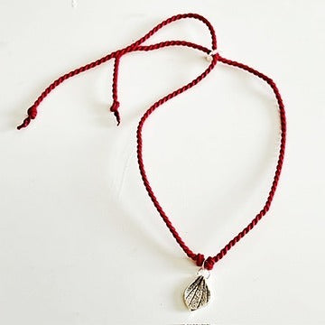 Handmade red silk string bracelet with silver leaf charm, crafted in Ireland, symbol of luck and love
Handmade red silk bracelet with silver bird charm, artisanal Irish jewellery