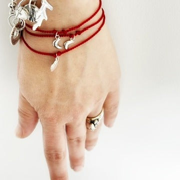 Handmade red silk string bracelet with silver leaf charm, crafted in Ireland, symbol of luck and love
Handmade red silk bracelet with silver bird charm, artisanal Irish jewellery
